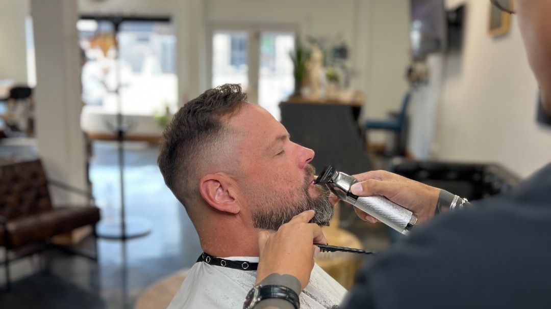 Barber performing a precision fade at Bison Barbers